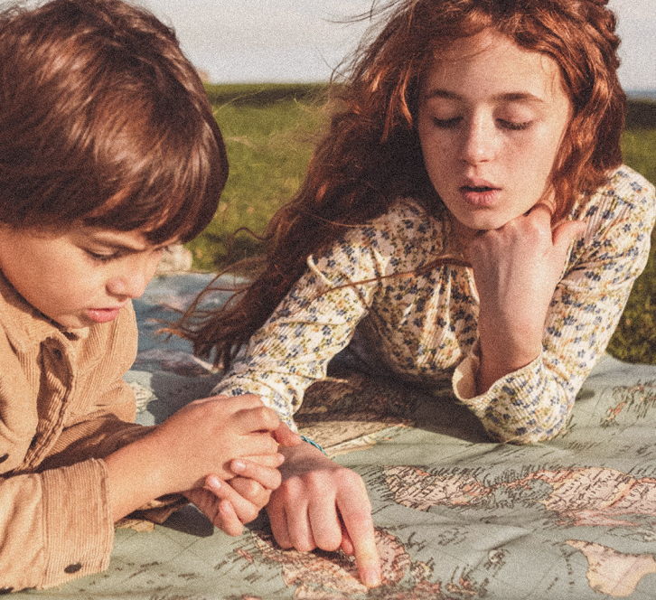 Children reading outdoors